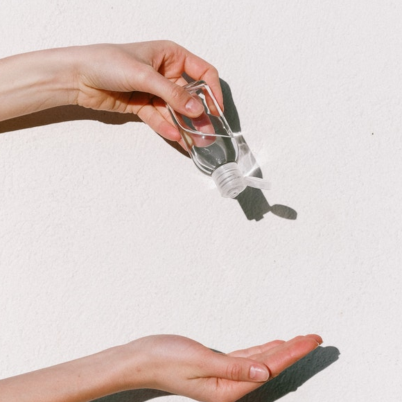 person holding hand sanitizer